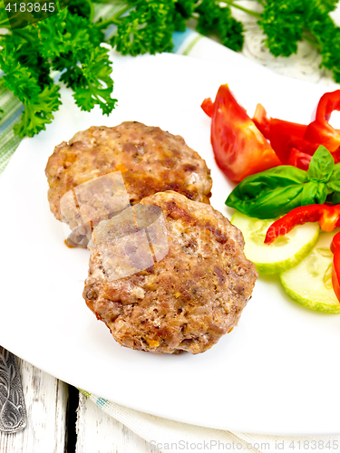 Image of Cutlets stuffed with basil in white plate on board