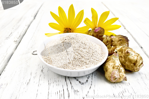 Image of Flour of Jerusalem artichoke in bowl with flower on board