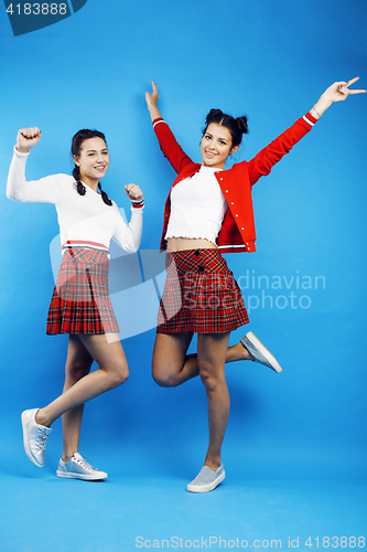 Image of best friends teenage school girls together having fun, posing emotional on blue background, besties happy smiling, lifestyle people concept 
