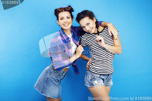 Image of best friends teenage school girls together having fun, posing emotional on blue background, besties happy smiling, lifestyle people concept 