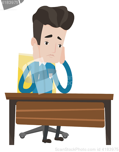 Image of Exhausted sad student sitting at the table.