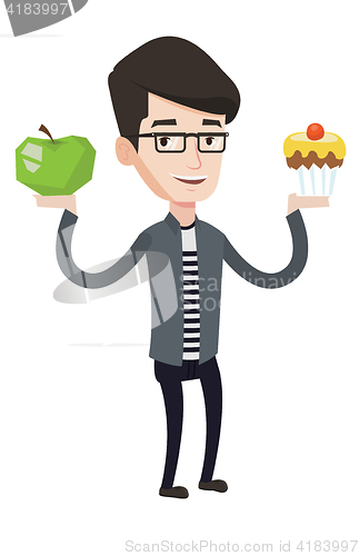 Image of Man choosing between apple and cupcake.