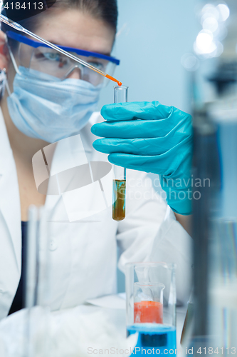 Image of Young technician with chemical substances