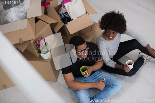 Image of African American couple relaxing in new house