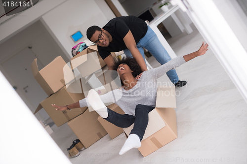 Image of African American couple  playing with packing material