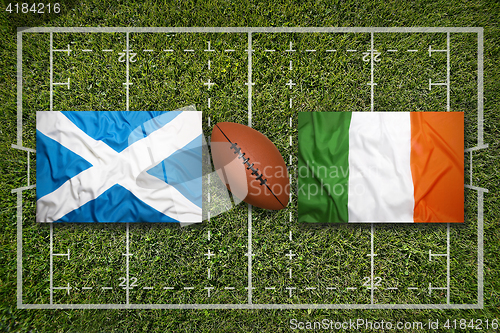 Image of Scotland vs. Ireland flags on rugby field