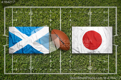 Image of Scotland vs. Japan flags on rugby field