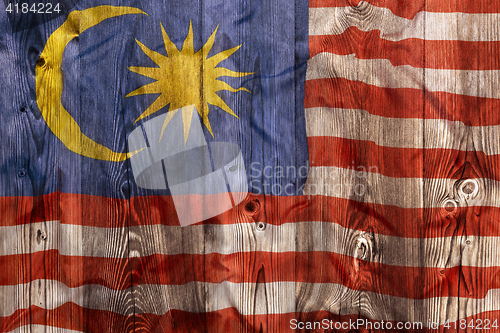 Image of National flag of Malaysia, wooden background