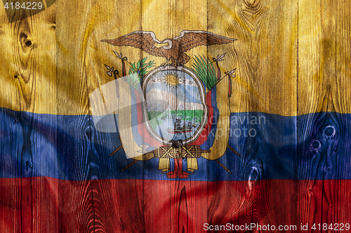 Image of National flag of Ecuador, wooden background