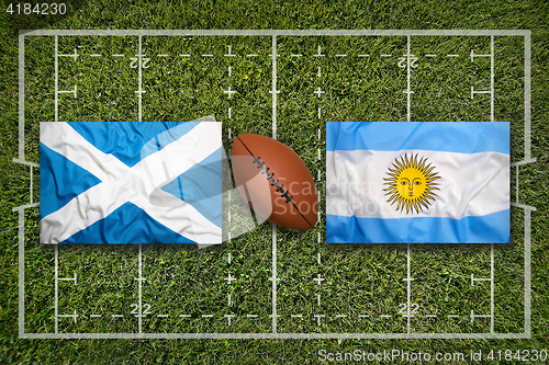 Image of Scotland vs. Argentina flags on rugby field