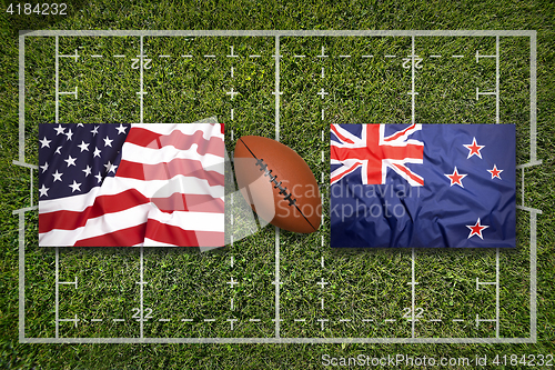 Image of USA vs. New Zealand flags on rugby field