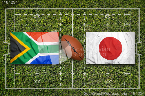 Image of South Africa vs. Japan flags on rugby field