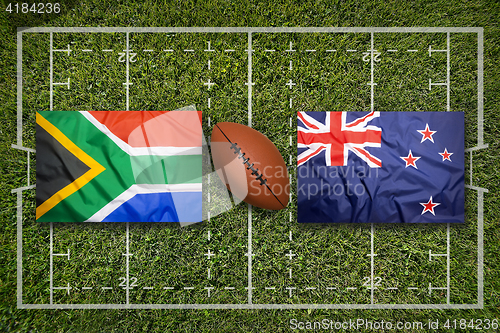 Image of South Africa vs. New Zealand flags on rugby field