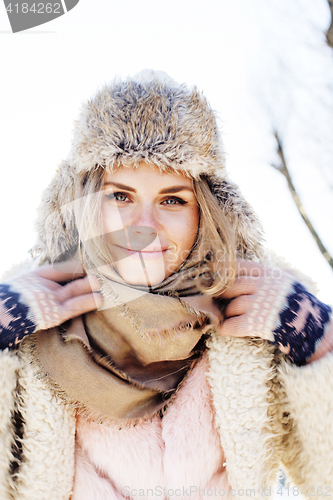 Image of young pretty teenage hipster girl outdoor in winter snow park having fun drinking coffee, warming up happy smiling, lifestyle people concept