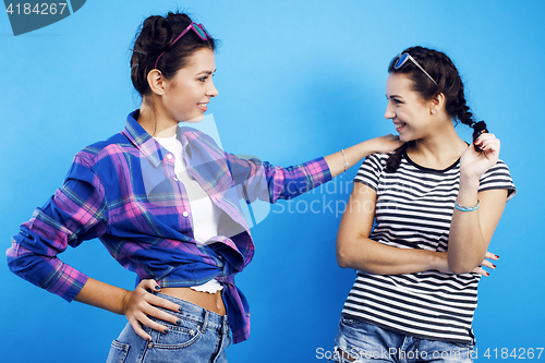 Image of best friends teenage school girls together having fun, posing emotional on blue background, besties happy smiling, lifestyle people concept 