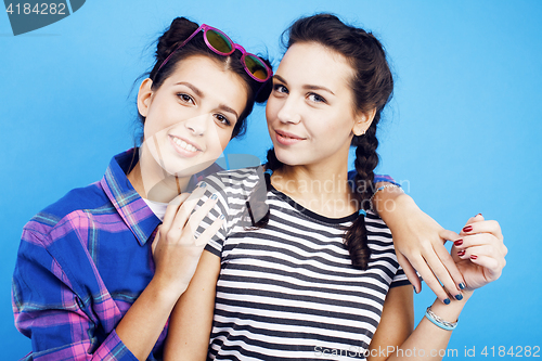 Image of best friends teenage school girls together having fun, posing emotional on blue background, besties happy smiling, lifestyle people concept 