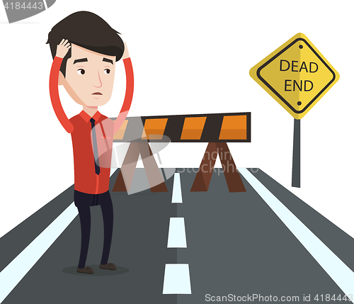 Image of Businessman looking at road sign dead end.