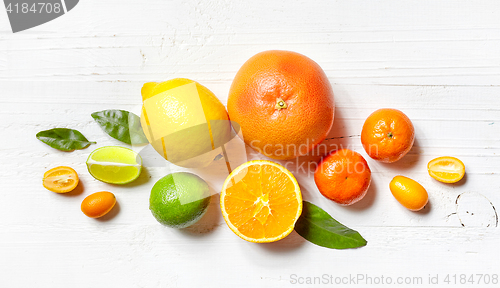 Image of various citrus fruits on white wooden table