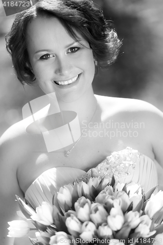 Image of Happy bride with wedding bouquet.