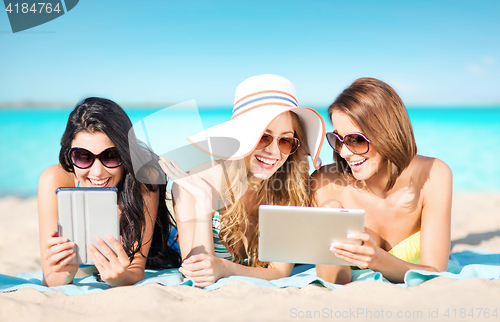 Image of happy young women with tablet pc on summer beach