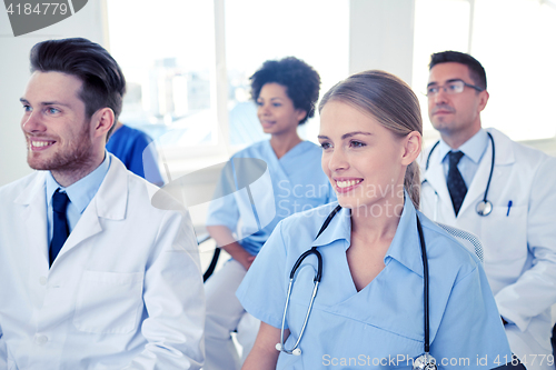 Image of group of happy doctors on seminar at hospital