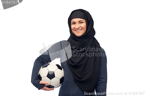 Image of happy muslim woman in hijab with football