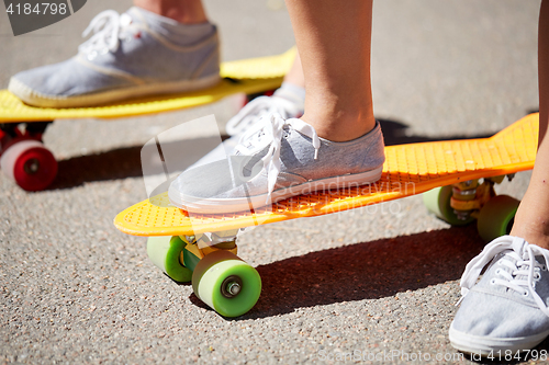 Image of close up of female feet riding short skateboard