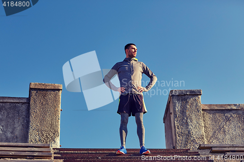 Image of happy man on stadium stair