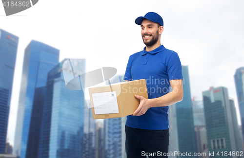 Image of happy delivery man with parcel box