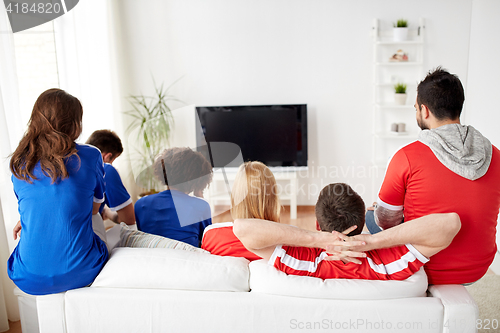 Image of friends or football fans watching tv at home