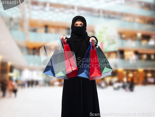 Image of muslim woman in hijab with shopping bags