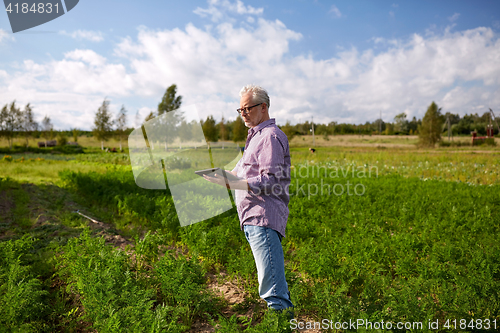 Image of senior man with tablet pc computer at county