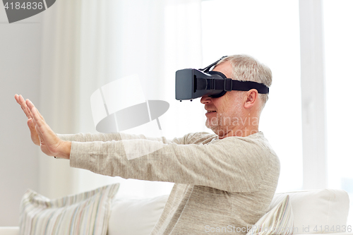 Image of old man in virtual reality headset or 3d glasses