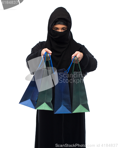 Image of muslim woman in hijab with shopping bags