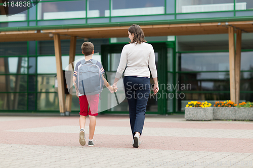 Image of elementary student boy with mother going to school