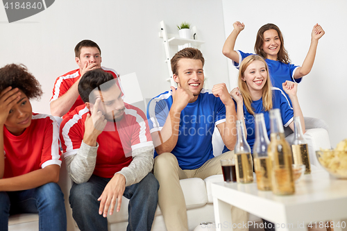 Image of friends or football fans watching soccer at home