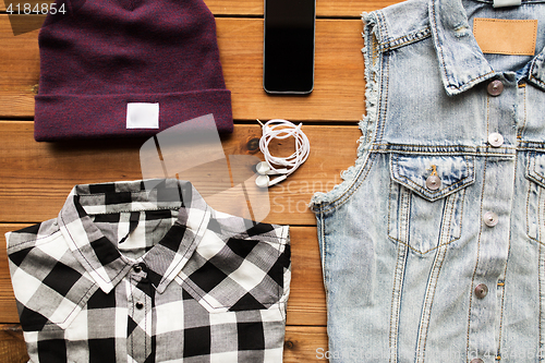 Image of clothes and smartphone with earphones