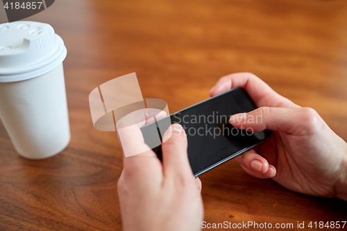 Image of close up of woman with smartphone and coffee
