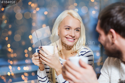 Image of happy couple meeting and drinking tea or coffee