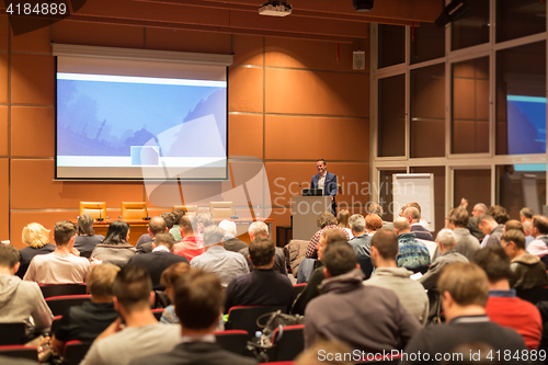 Image of Business speaker giving a talk in conference hall.