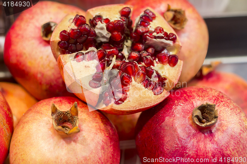 Image of Ripe Juicy pomegranates on market close up