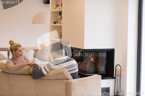 Image of Young couple  in front of fireplace