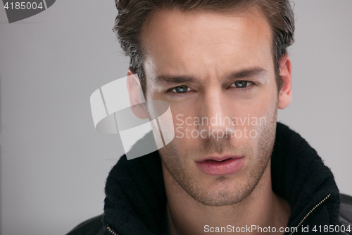 Image of portrait of a young guy over gray background