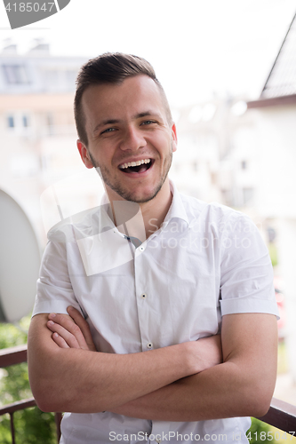 Image of man standing at balcony