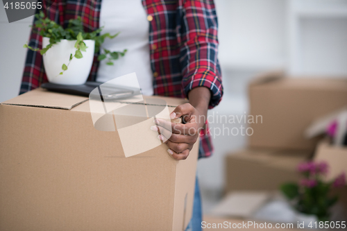 Image of Black girl moving in the new apartment