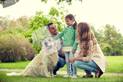 Image of happy family with labrador retriever dog in park