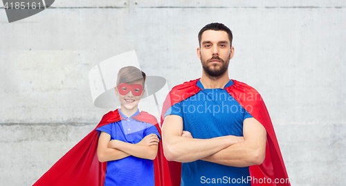 Image of man and boy wearing mask and red superhero cape