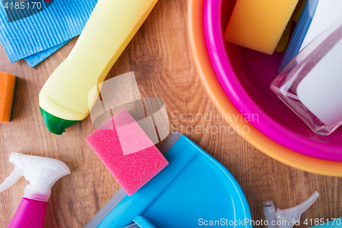 Image of basin with cleaning stuff on wooden floor