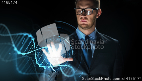 Image of businessman with virtual dna molecule projection