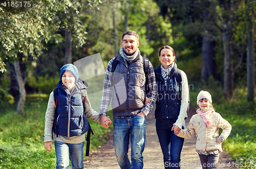 Image of happy family with backpacks hiking